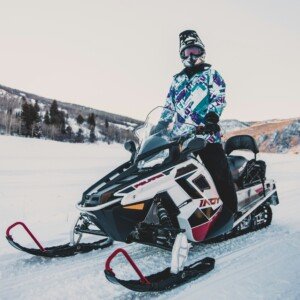 Man driving snowmobile in the middle of lake